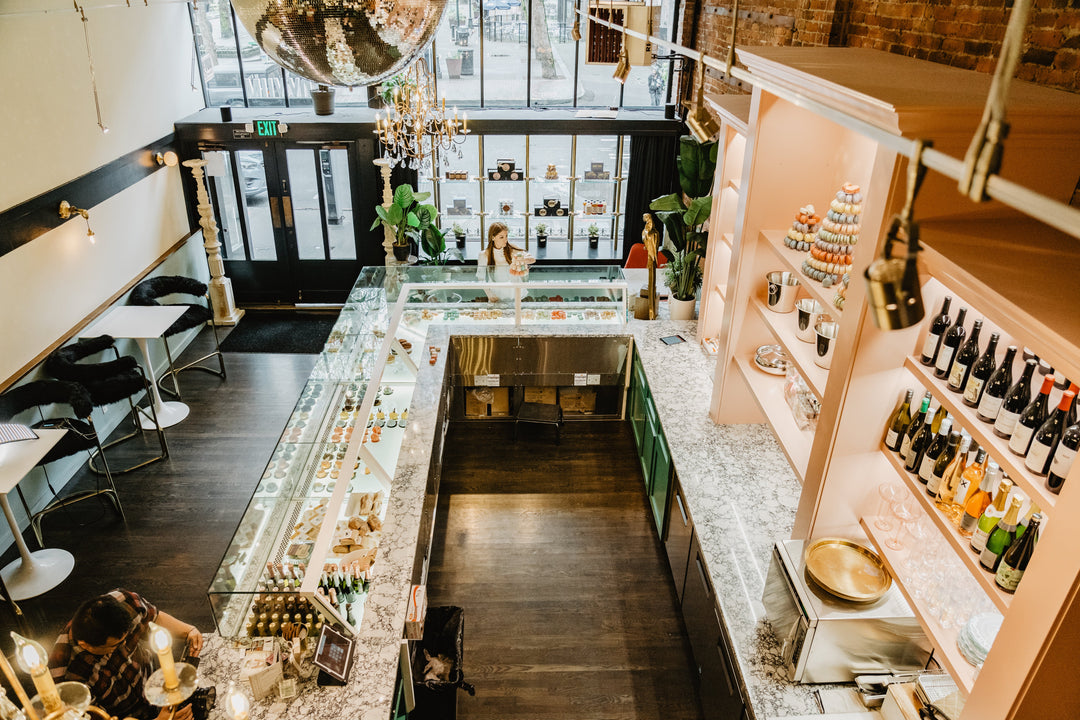 A birds eye view of Pioneer Square Lady Yum, looking down from a balcony at a disco ball and macaron case piled high with cookies.